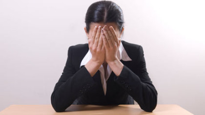 Business woman crying head in hands