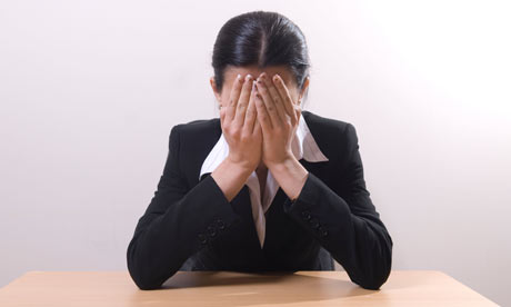 Business woman crying head in hands